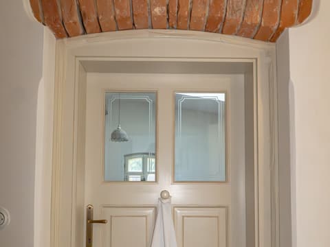 Elegantní interiérové dveře z masivu vybavené ozdobným pískovaným prosklením a mosaznou klikou.